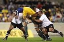 Australia lock Nathan Sharpe powers through a Fijian tackle