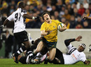 Adam Ashley-Cooper is caught by a Fijian tackler