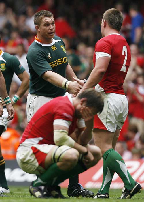 South Africa captain John Smit shakes hands with Wales hooker Matthew Rees