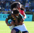 Francois Venter of South Africa is tackled against Tonga