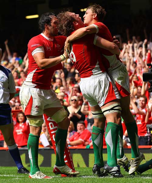 Tom Prydie is congratulated after scoring his first try for Wales