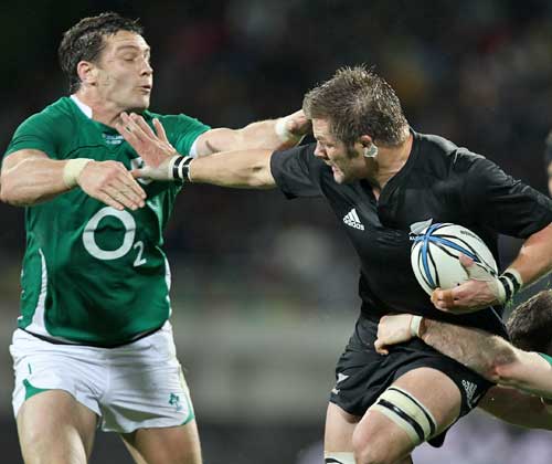 New Zealand's Richie McCaw fends off Ireland's David Wallace