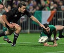 New Zealand's Conrad Smith pounces on an error by Ireland's Rob Kearney