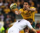 Australia wing Digby Ioane is smashed by Mark Cueto