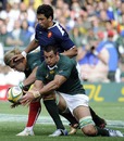 South Africa No.8 Pierre Spies competes for the ball with Maxime Mermoz