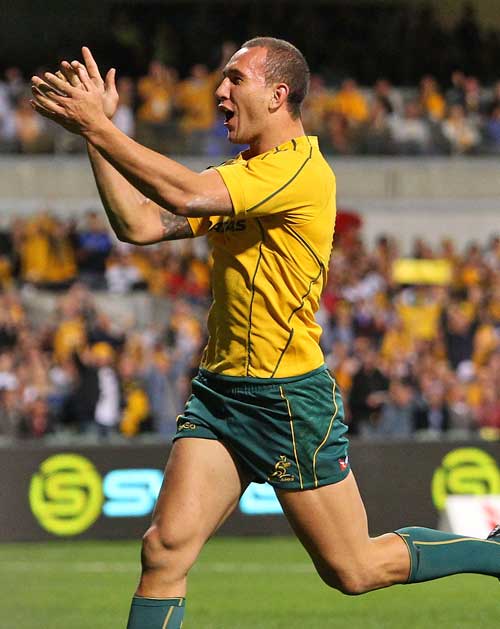Australia's Quade Cooper celebrates scoring a try