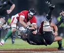 Wales' Jonathan Thomas and New Zealand's Richie McCaw vie for the ball