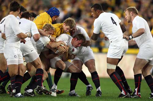 England wing Mark Cueto is swallowed up by the Australian defence