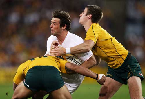 England fullback Ben Foden feels the force of the Australian defence