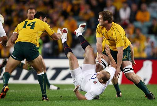 England centre Mike Tindall is sent flying