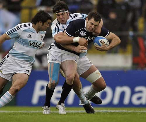 Scotland's Sean Lamont is shackled by the Argentina defence