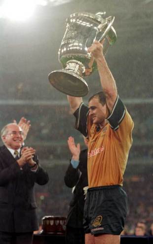 Australia captain David Wilson lifts the Bledisloe Cup following his side's 28-7 win over New Zealand in front of a crowd of 108,000 at Stadium Australia. Australia v New Zealand, Tri Nations, Stadium Australia, August 28 1999.