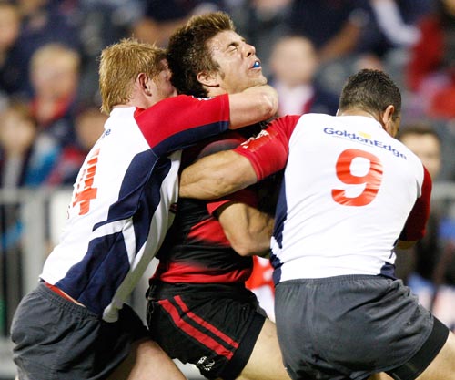 James Paterson of Canterbury is tackled by Blair Cook (L)and Kahn Fotuali'i (R) of Tasman