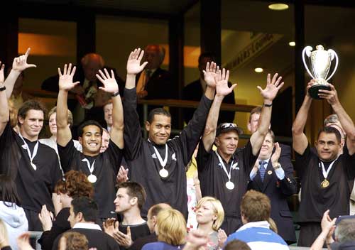 New Zealand captain Eric Rush lifts the 2003 IRB Sevens trophy