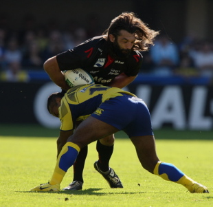 Sebastien Chabal of Sale is tackled by Seremaia Bai during the Heineken Cup match between ASM Clermont Auvergne v Sale Sharks at Stade Marcel Michelin on October 11, 2008 in Clermont-Ferrand, France.