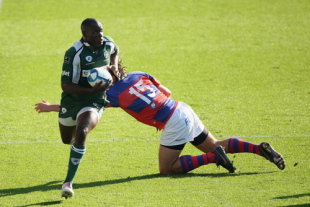 Topsy Ojo of London Irish evades a tackle from Nicola Pavin of Rovigo during the European Challenge Cup match between London Irish and Rugby Rovigo at the Madejski Stadium on October 11, 2008 in Reading, England. 