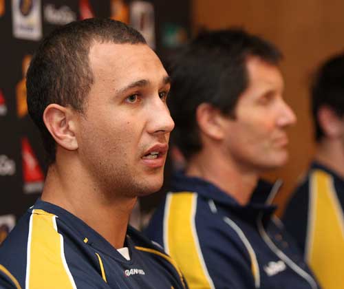 Australia's Quade Cooper sits alongside coach Robbie Deans