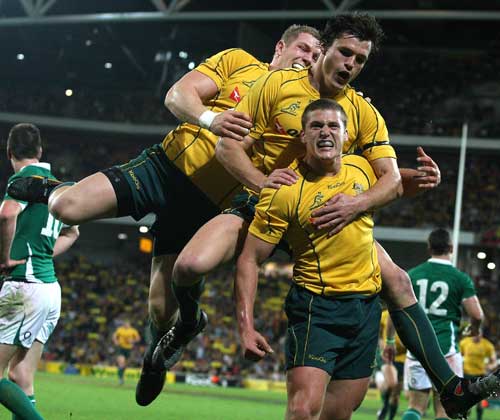 Australia scrum-half Luke Burgess is congratulated after scoring his side's first try
