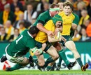 Australia centre Matt Giteau is swamped by the Irish defence