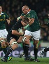 Brad Thorn fends off a tackle from Gurthro Steenkamp