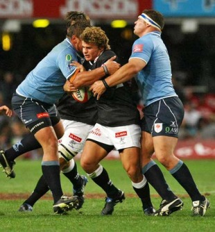 The Sharks' Patrick Lambie is tackled by the Blue Bulls' defence, Natal Sharks v Blue Bulls, Currie Cup, ABSA Stadium, Durban, South Africa, July 17, 2010