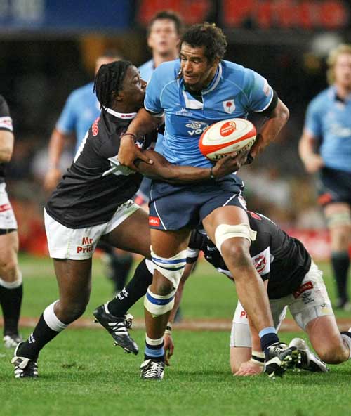 The Blue Bulls' Fudge Mabeta is tackled by the Sharks' Lwazi Mvovo