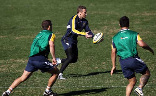 Australia centre Matt Giteau passes during training