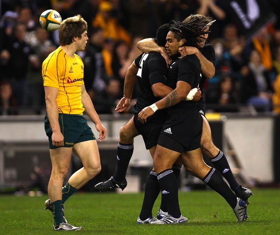 Mils Muliaina is congratulated by his All Blacks team-mates