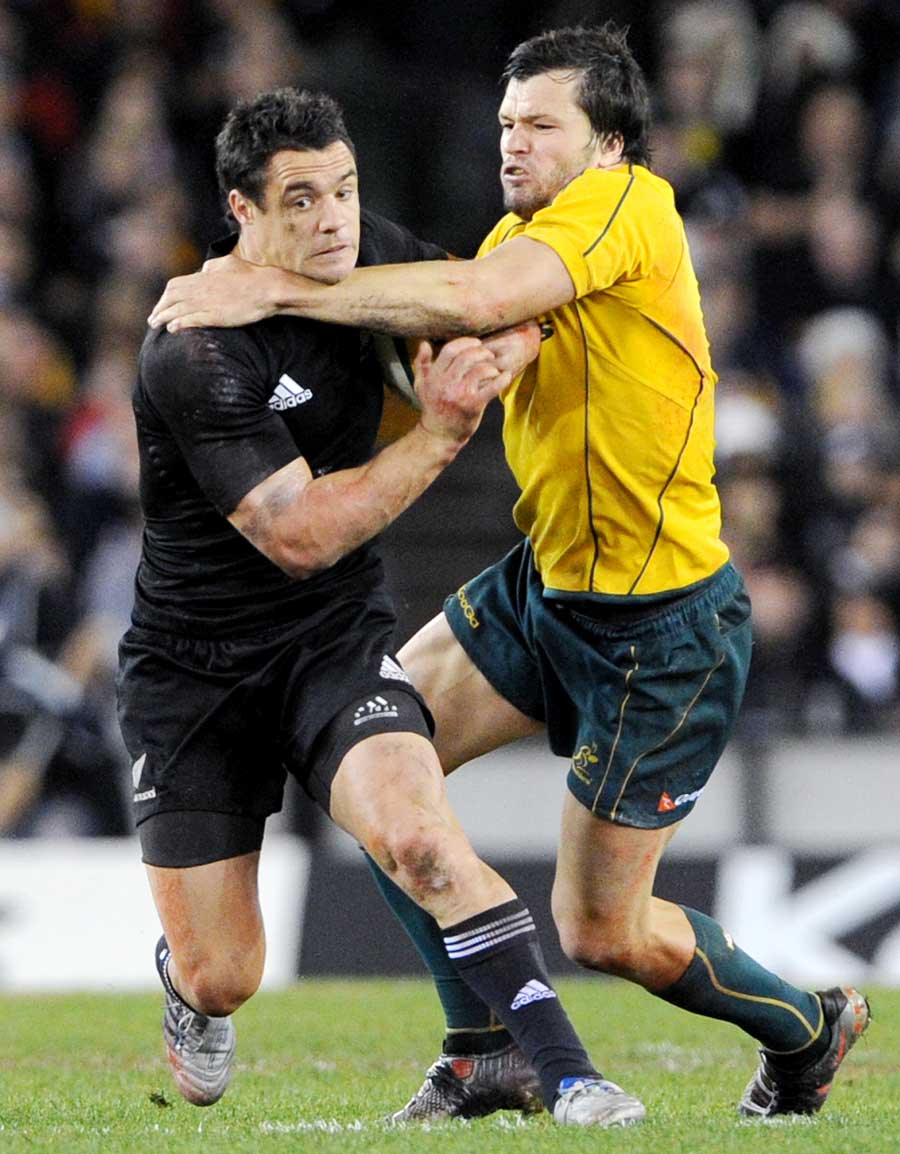 New Zealand fly-half Dan Carter fends off Adam Ashley-Cooper