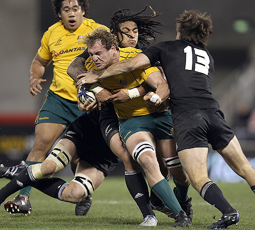 Wallabies captain Rocky Elsom is tackled by New Zealand's centres