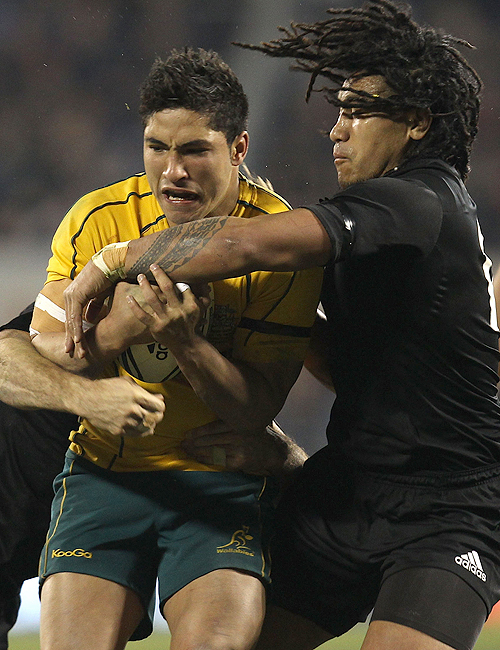 Wallabies debutant Anthony Faingaa is grabbed by opposing No.12 Ma'a Nonu