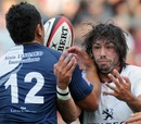 Toulouse fullback Clement Poitrenaud forces an offload