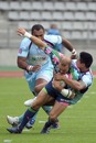 Stade Francais wing Ollie Phillips is hauled to the ground
