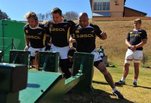 The Springbok front-row, Jannie du Plessis, John Smit and Gurthro Steenkamp, prepares to pack down during training at Hyde Park High School, Johannesburg, South Africa, August 16, 2010