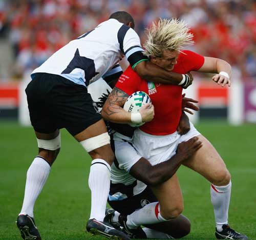 Alix Popham is tackled by the Fiji defence