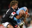 Blue Bulls prop Bees Roux is tackled by Patrick Lambie