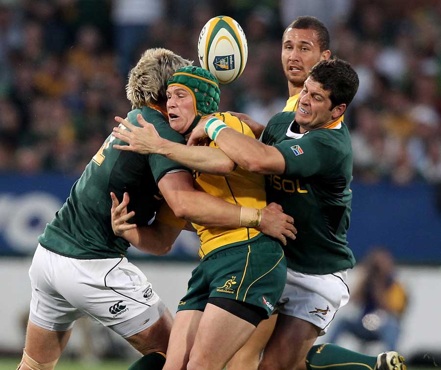 Australia's Matt Giteau is tackled by the South Africa defence