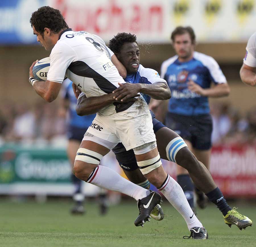 Montpellier's Fulgence Ouedraogo  tackles Toulouse's Gregory Lamboley