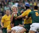 Springbok flanker Schalk Burger is wrapped up by the Wallabies