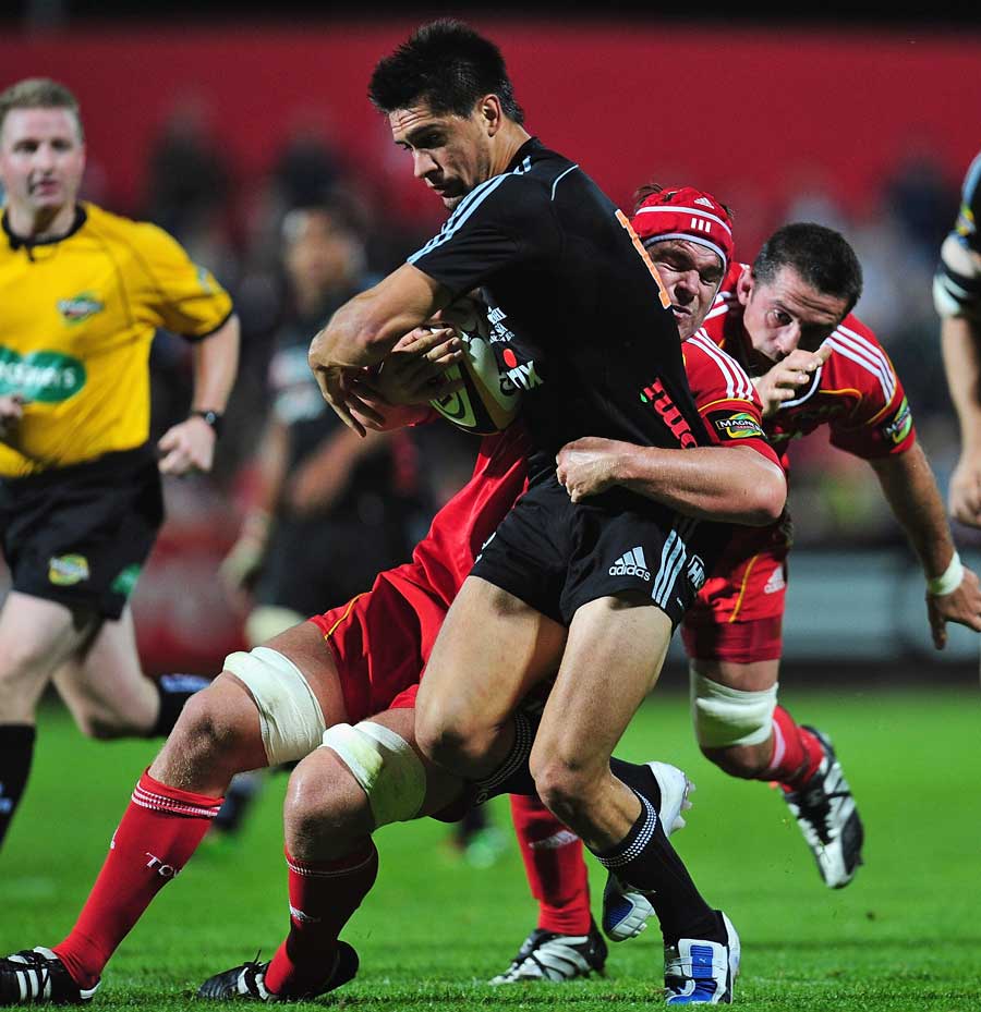 Aironi's Roberto Quartaroli is shackled by the Munster defence