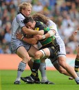 Northampton's Phil Dowson is wrapped up by the Leicester defence
