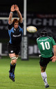 Connacht's Ian Keatley clears under pressure from Rob Harley