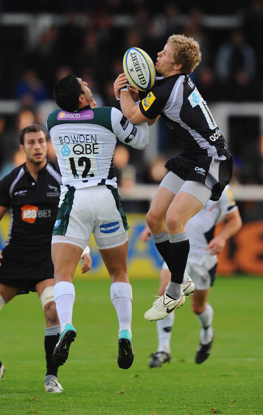 Newcastle's Alex Tait vies with Dan Bowden for a high ball