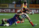 Waikato fullback Mils Muliaina offloads out of a tackle
