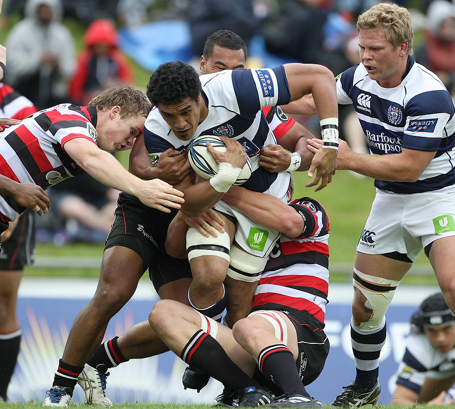 Auckland's Jerome Kaino is tackled by the Counties Manukau defence