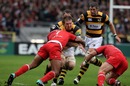 Andy Powell is halted by Toulouse flanker Thierry Dusautoir