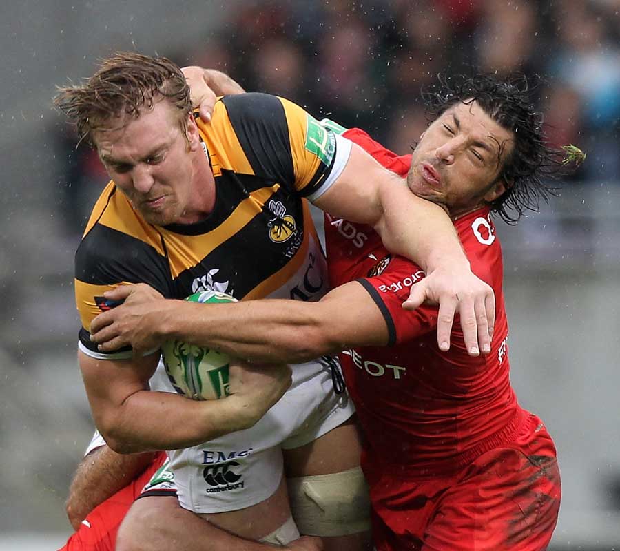 Wasps' Andy Powell is caught by Toulouse's Byron Kelleher