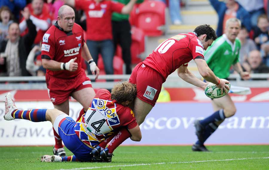 Scarlets fly-half Stephen Jones dives in for a try