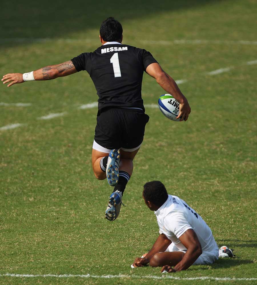New Zealand's Liam Messam leaps clear of an England tackler