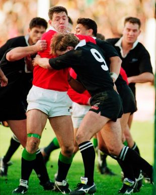 Gavin Hastings of the British Lions is wrapped up by New Zealand's Jon Preston and John Timu during the Second Test Match between New Zealand and the British Lions at Athletic Park in Wellington, New Zealand on June 26, 1993.